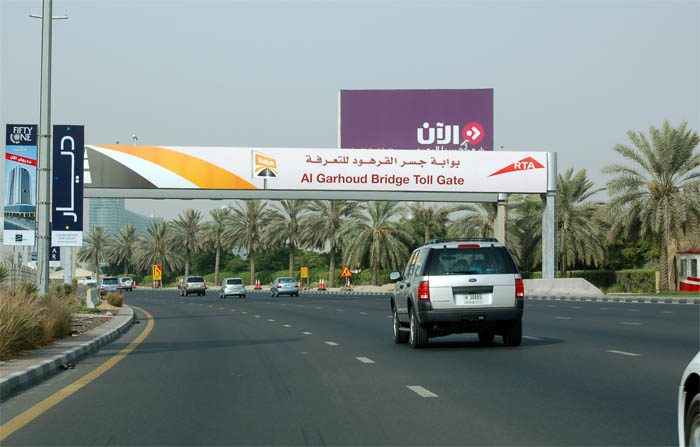 Salik electronic toll gantry at Al Garhoud Bridge in Dubai, showing overhead RFID readers and RTA signage